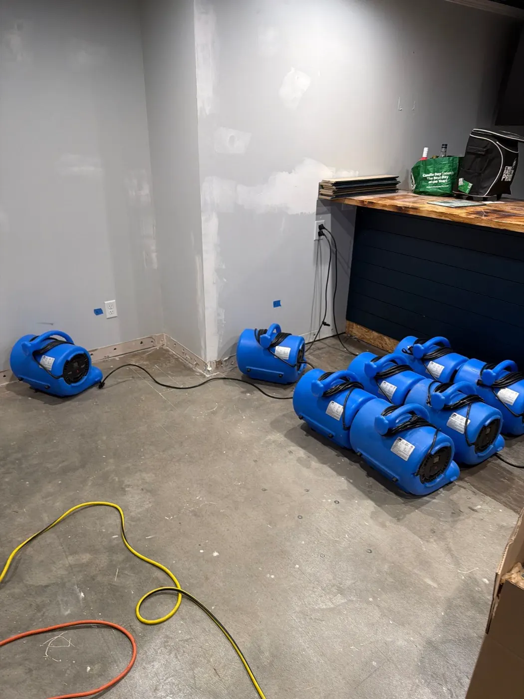 Air movers and dehumidifiers running during a water damage dry-out, serving Belleville